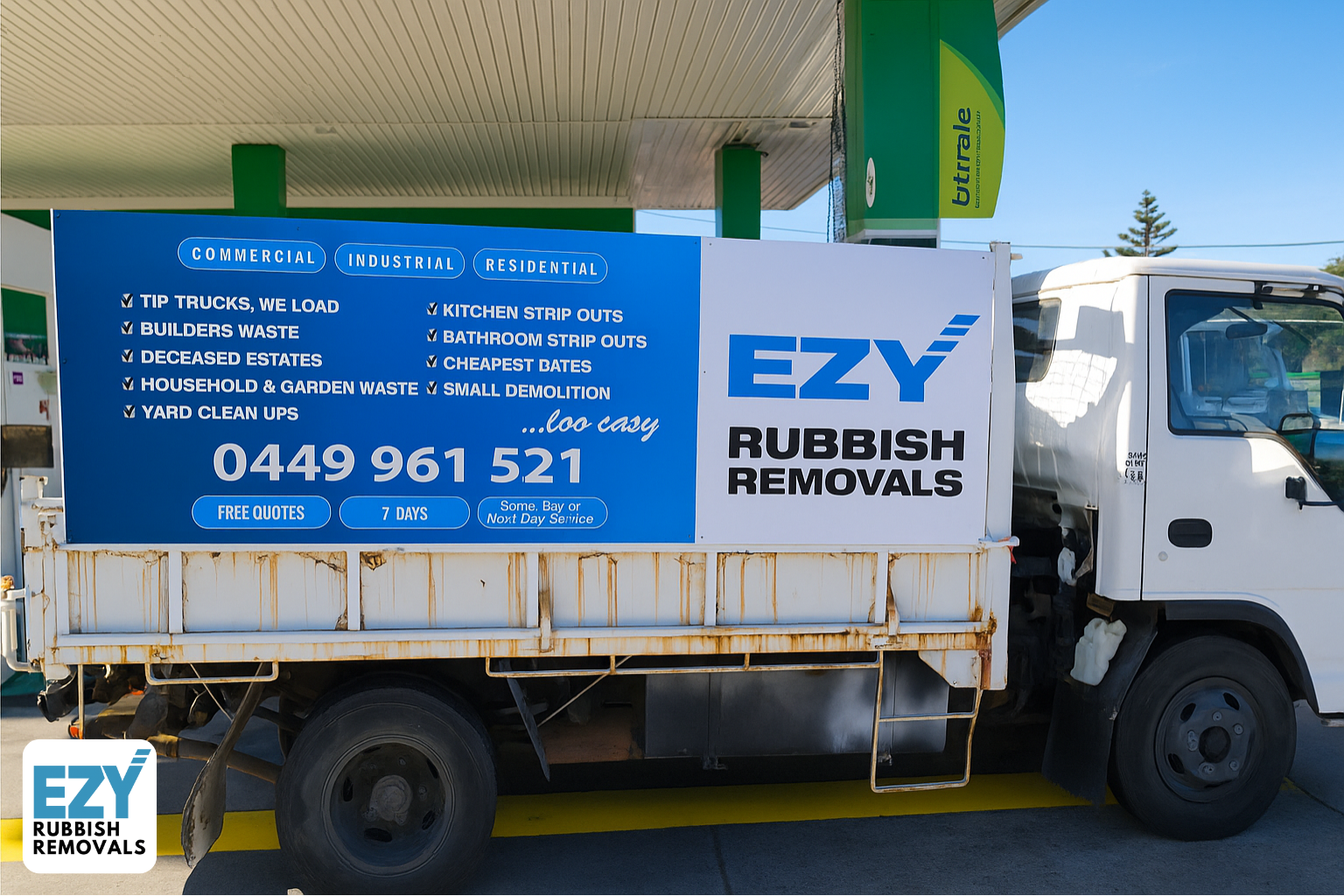 EZY Rubbish Removals truck parked at a petrol station displaying services like builders waste, yard cleanups, strip outs, and small demolition, with contact number 0449 961 521 and a “same or next day service” guarantee.